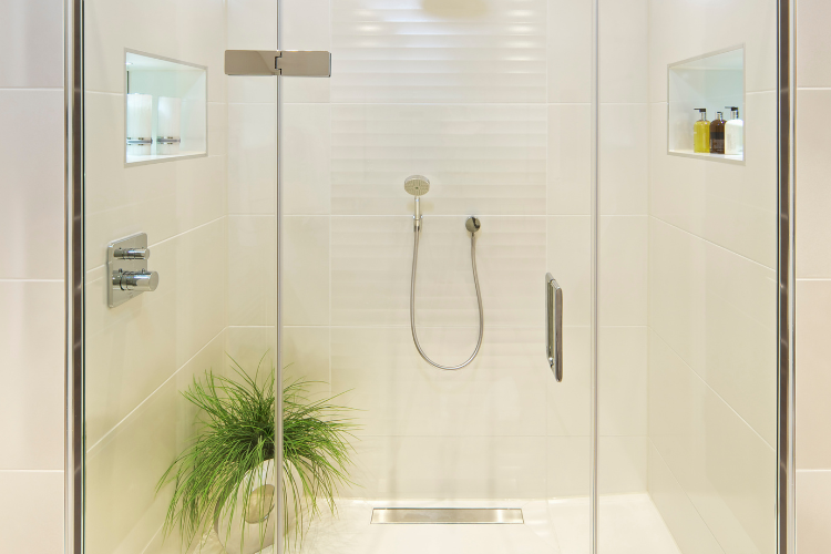 Frameless glass shower door enclosure with clean tile — identifying your door type is the first step