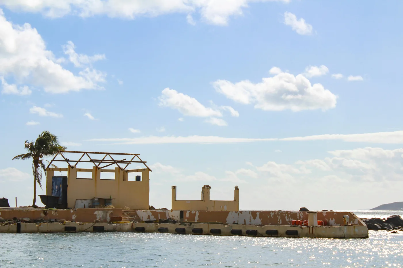 Hurricane-damaged coastal building with missing roof structure, a reminder of why Florida insurers reward homes that prove their windstorm protection