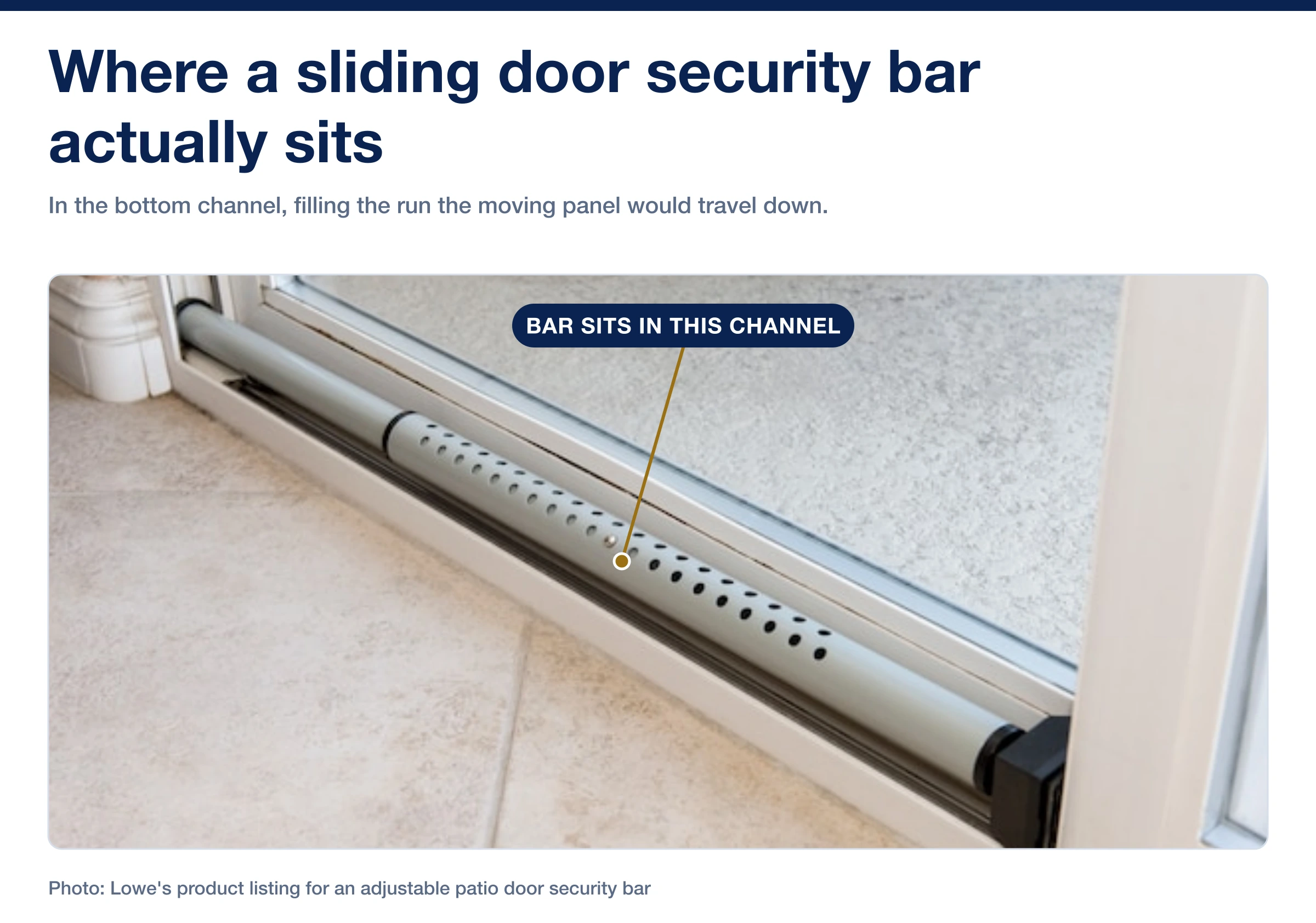 An adjustable security bar sitting in the bottom track of a sliding patio door, with its end block against the frame