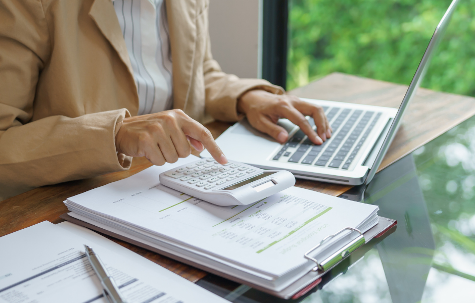 Woman calculating sliding door repair costs with laptop and documents