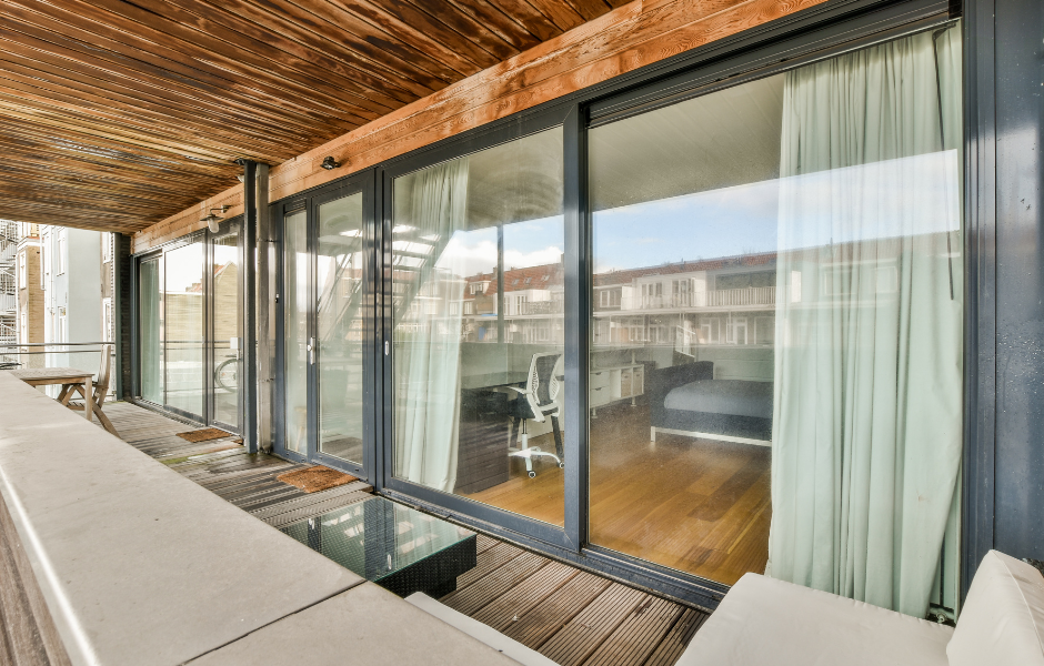 Modern sliding glass door with ocean view — finding the right replacement rollers for your door model