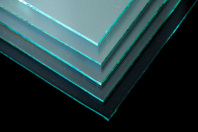 Stacked tempered glass panels showing the layered edges of safety glazing