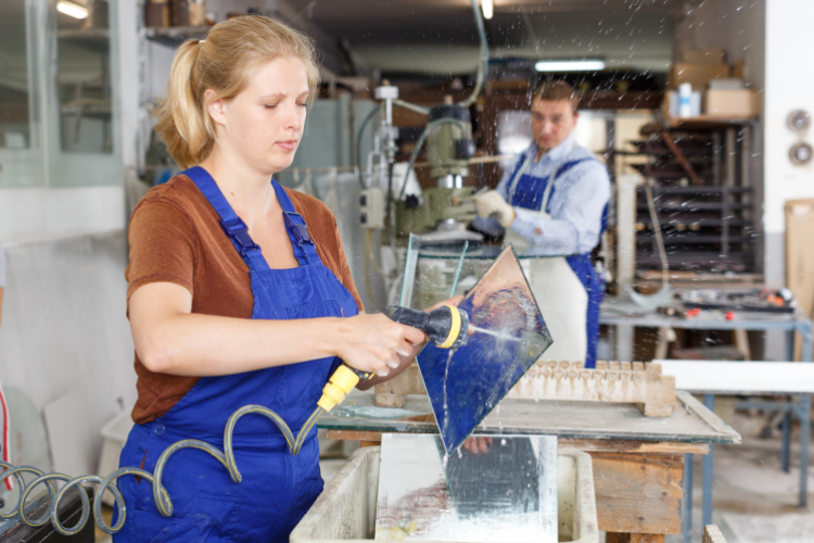 Professional cutting glass in a workshop — tempered glass must be cut before the tempering process