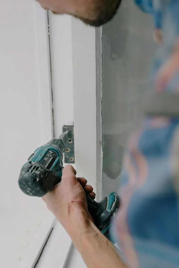 Close-up of a hinge repair on a residential window, the kind of detailed fix that runs $150 to $400 in Broward
