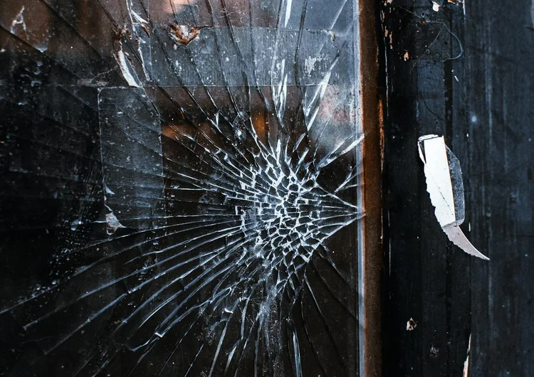 Cracked glass with a spider-web fracture pattern, a common South Florida hazard from debris and storm impact
