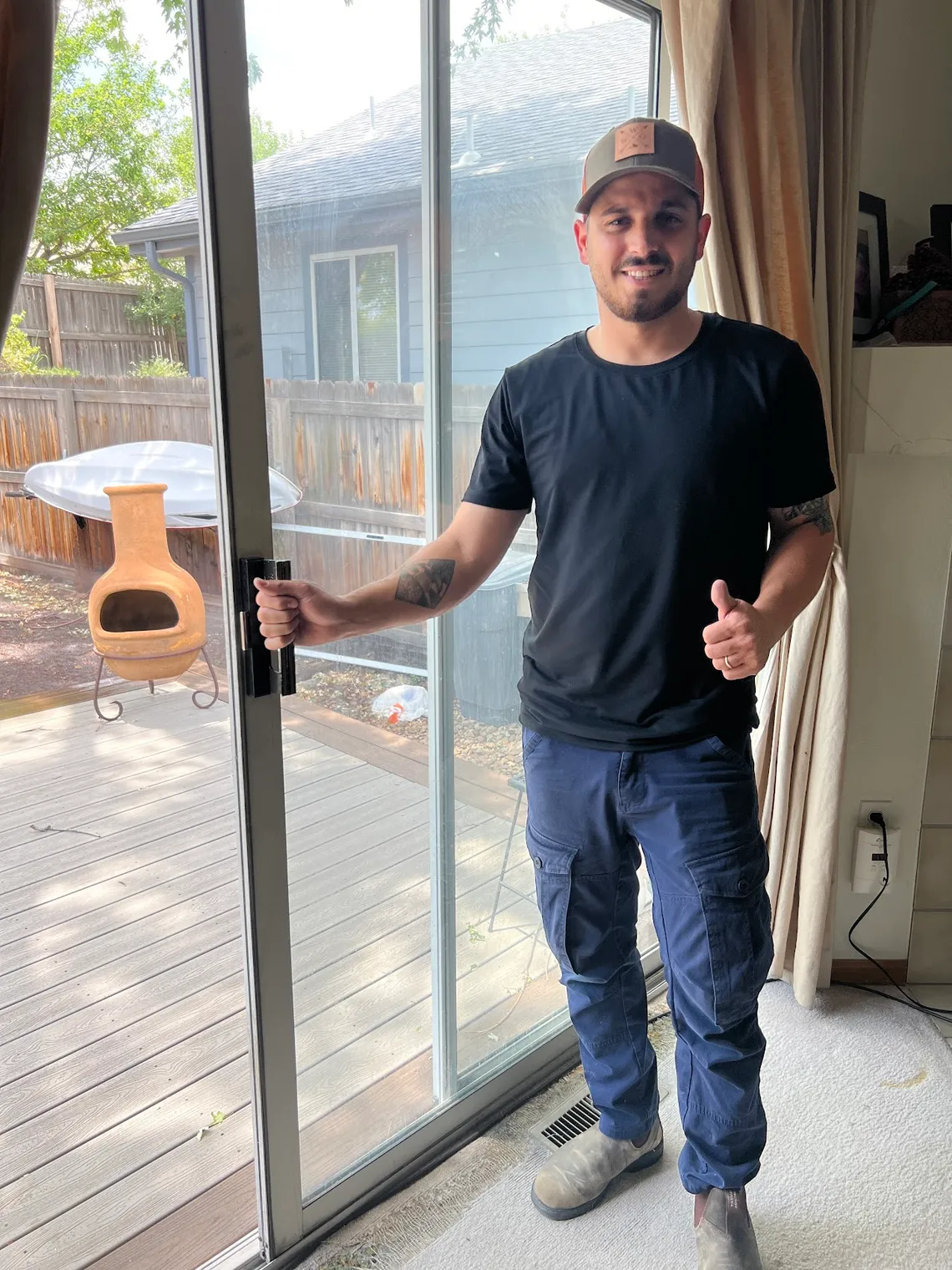 JDM technician beside a freshly repaired residential patio sliding glass door in Colorado