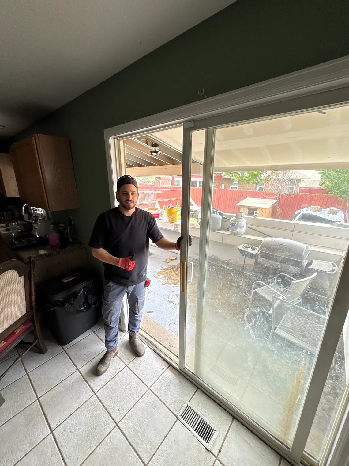 JDM technician repairing a residential kitchen patio sliding glass door in Colorado