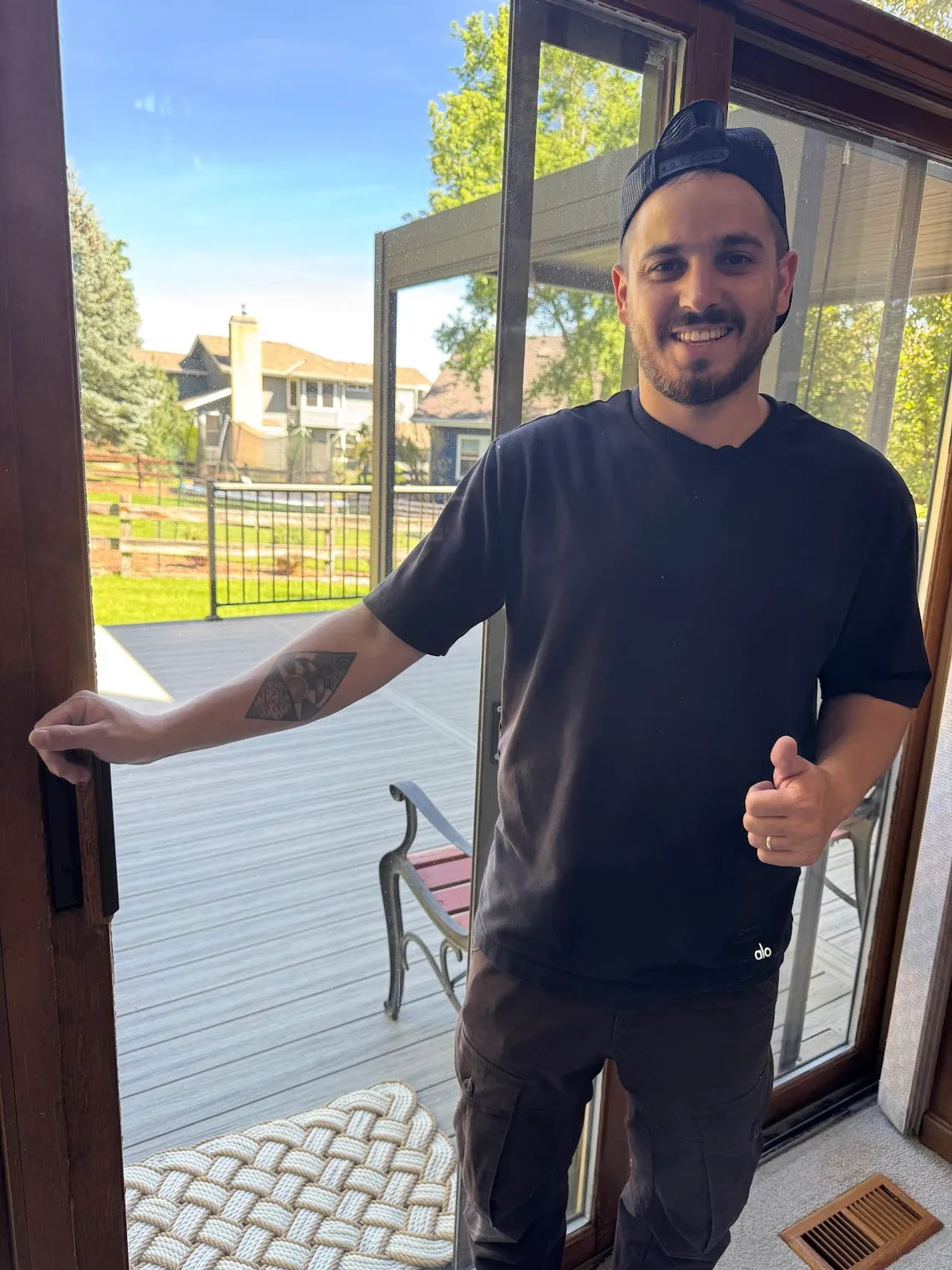 JDM technician after a sliding screen door repair on a Colorado home deck