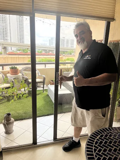 JDM technician after a sliding glass door repair on a Florida balcony
