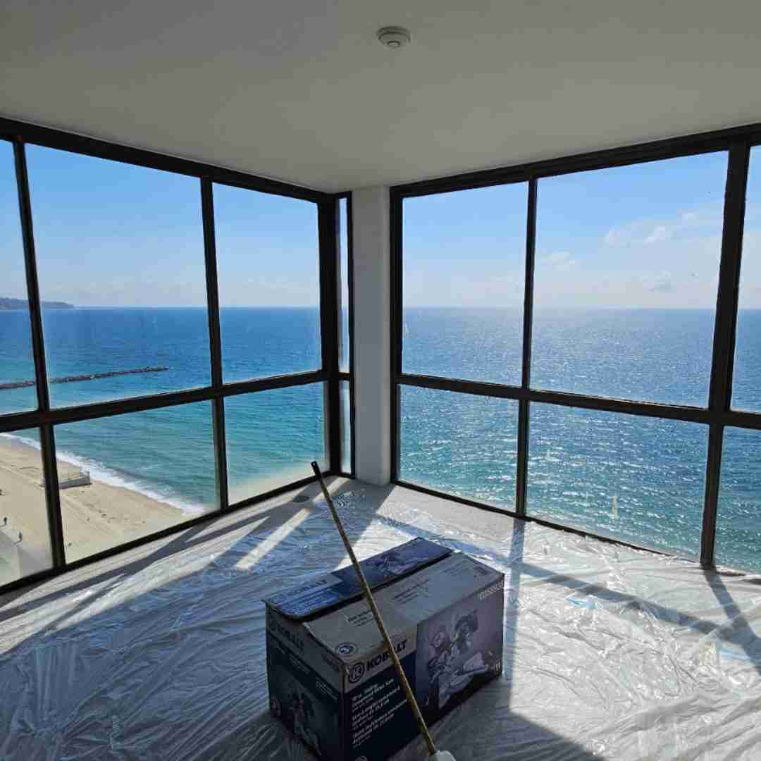 JDM impact window installation with ocean view